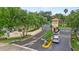 A community entrance with a clock tower, gate, and well-maintained landscaping with mature trees at 2867 Club Cortile Cir, Kissimmee, FL 34746