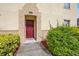 Inviting entrance showcasing a red front door, well-maintained landscaping, and a welcoming walkway at 2867 Club Cortile Cir, Kissimmee, FL 34746