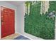 A bright entryway with a red door, stylish green wall decor, and a welcoming blue rug at 2867 Club Cortile Cir, Kissimmee, FL 34746