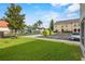 Exterior of the home highlighting the lush green space and nearby playground at 2867 Club Cortile Cir, Kissimmee, FL 34746