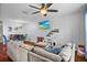 Comfortable living room featuring hardwood floors, a sectional sofa, mounted television, and dining area at 2867 Club Cortile Cir, Kissimmee, FL 34746