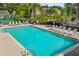 View of a community pool with lounge chairs and a jacuzzi at 2867 Club Cortile Cir, Kissimmee, FL 34746