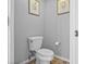 Cozy powder room with toilet and neutral paint at 2867 Club Cortile Cir, Kissimmee, FL 34746