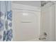 Bathtub with integrated shower, subway tile surround, and a decorative shower curtain at 2867 Club Cortile Cir, Kissimmee, FL 34746