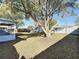 A large shady tree is the focal point in this big backyard with a privacy fence and covered porch at 430 Short Dr, Kissimmee, FL 34759