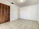 Clean bedroom featuring tile floors, a closet, and neutral walls, ready for personalization at 430 Short Dr, Kissimmee, FL 34759