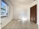 Bright bedroom with tile flooring, closet, and natural light, providing a cozy and functional space at 430 Short Dr, Kissimmee, FL 34759