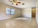 Inviting living room with tile floors, a ceiling fan, and natural light, creating a cozy atmosphere at 430 Short Dr, Kissimmee, FL 34759