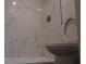 Bathroom featuring a stand up shower with modern, marbled tile walls at 4378 Aqua Vista Dr # L, Orlando, FL 32839