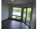 Bright room with pool view from windows and sliding glass door to balcony at 4378 Aqua Vista Dr # L, Orlando, FL 32839