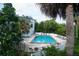 Image of the community pool area with lounge chairs and trees in the background at 4378 Aqua Vista Dr # L, Orlando, FL 32839