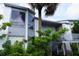 Two-story condo with palm tree, staircase entry, and ample greenery at 4378 Aqua Vista Dr # L, Orlando, FL 32839