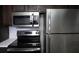 Updated kitchen with stainless steel appliances and dark wooden cabinets at 4378 Aqua Vista Dr # L, Orlando, FL 32839
