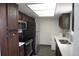 Kitchen with stainless steel appliances, wood cabinets, and laundry at 4378 Aqua Vista Dr # L, Orlando, FL 32839