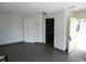 Open-concept living room with tile floors, neutral walls, and doorway to kitchen at 4378 Aqua Vista Dr # L, Orlando, FL 32839