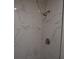 Modern shower featuring marble-patterned tile and sleek fixtures at 4378 Aqua Vista Dr # L, Orlando, FL 32839
