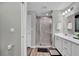 Well-lit bathroom featuring dual-sink vanity with modern fixtures and a glass-door shower at 4501 Hummingbird Ln, Haines City, FL 33844