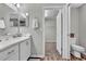 Bathroom featuring a single sink vanity and an open doorway to a carpeted walk-in closet at 4501 Hummingbird Ln, Haines City, FL 33844