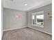 Cozy bedroom with a large window and neutral carpeting, perfect for relaxation at 4501 Hummingbird Ln, Haines City, FL 33844