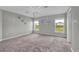 Spacious bedroom with plush carpeting, natural light, and coastal-themed wall art at 4501 Hummingbird Ln, Haines City, FL 33844