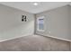Comfortable bedroom with soft carpeting and a window providing natural light at 4501 Hummingbird Ln, Haines City, FL 33844