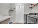 Neat laundry room featuring modern appliances, shelving, and stylish wood-look flooring at 4501 Hummingbird Ln, Haines City, FL 33844
