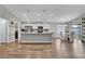 Bright open-concept living room with hardwood floors, kitchen view, and dining area at 4501 Hummingbird Ln, Haines City, FL 33844