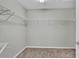 Spacious walk-in closet with wire shelving, carpeted floor, and overhead lighting at 4501 Hummingbird Ln, Haines City, FL 33844