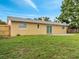 Spacious backyard with a well-maintained lawn, a concrete patio, and mature trees at 4521 Alrix Dr, Orlando, FL 32839