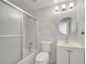 Updated bathroom features a shower-tub combo, white vanity, and a round mirror at 4521 Alrix Dr, Orlando, FL 32839