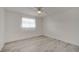 Bright bedroom features wood-look flooring, a ceiling fan, and a window with natural light at 4521 Alrix Dr, Orlando, FL 32839