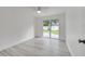 Bedroom with sliding glass doors offering backyard views, light-colored walls and light gray wood-look flooring at 4521 Alrix Dr, Orlando, FL 32839