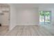 A bonus room with light gray flooring, neutral walls, and a sliding glass door leading to a patio at 4521 Alrix Dr, Orlando, FL 32839
