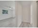 Hallway view of a bedroom featuring wood-look flooring and a ceiling fan at 4521 Alrix Dr, Orlando, FL 32839