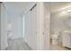 Hallway leading to a full bathroom featuring light gray wood-look floors, and light-colored walls at 4521 Alrix Dr, Orlando, FL 32839