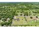 Aerial view of a serene property featuring a large lot, home, pool, and outbuildings in a tranquil setting at 4551 Hunting Lodge Dr, St Cloud, FL 34772
