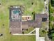 Aerial view of the property highlighting the screened pool, patio area, and extensive landscaping at 4551 Hunting Lodge Dr, St Cloud, FL 34772