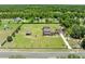 Expansive property featuring a beautiful home, large lawn, mature trees, and detached garage at 4551 Hunting Lodge Dr, St Cloud, FL 34772
