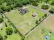 Beautiful estate featuring a custom home, sprawling lawn, screened in pool, and multiple outbuildings at 4551 Hunting Lodge Dr, St Cloud, FL 34772
