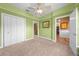 A bright bedroom with a ceiling fan, double closets, and ensuite bathroom at 4551 Hunting Lodge Dr, St Cloud, FL 34772