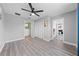 Bedroom with wood-look flooring, neutral walls, ceiling fan and easy access to other rooms at 4551 Hunting Lodge Dr, St Cloud, FL 34772