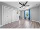 Spacious bedroom featuring wood-look floors, ceiling fan and plenty of natural light at 4551 Hunting Lodge Dr, St Cloud, FL 34772