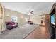 Large bonus room featuring ample seating, television, windows, and access to kitchen at 4551 Hunting Lodge Dr, St Cloud, FL 34772