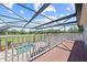 A wooden deck overlooks the pool, and lawn area, providing a scenic outdoor living space at 4551 Hunting Lodge Dr, St Cloud, FL 34772