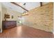 Dining room features a stone wall, hardwood floors and stylish furnishings creating a warm and inviting atmosphere at 4551 Hunting Lodge Dr, St Cloud, FL 34772