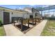 View of the backyard with raised garden beds and screened-in porch area at 4551 Hunting Lodge Dr, St Cloud, FL 34772