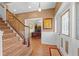 Inviting foyer with wood floors, staircase and view into the home office through the doorway at 4551 Hunting Lodge Dr, St Cloud, FL 34772