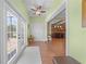 Foyer featuring hardwood floors, light green walls, and a pair of french doors at 4551 Hunting Lodge Dr, St Cloud, FL 34772