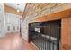 Foyer with wood floors, stone accent wall, and custom dog kennel under stairs at 4551 Hunting Lodge Dr, St Cloud, FL 34772