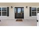 Charming front door flanked by decorative lights and windows, creating an inviting entrance at 4551 Hunting Lodge Dr, St Cloud, FL 34772